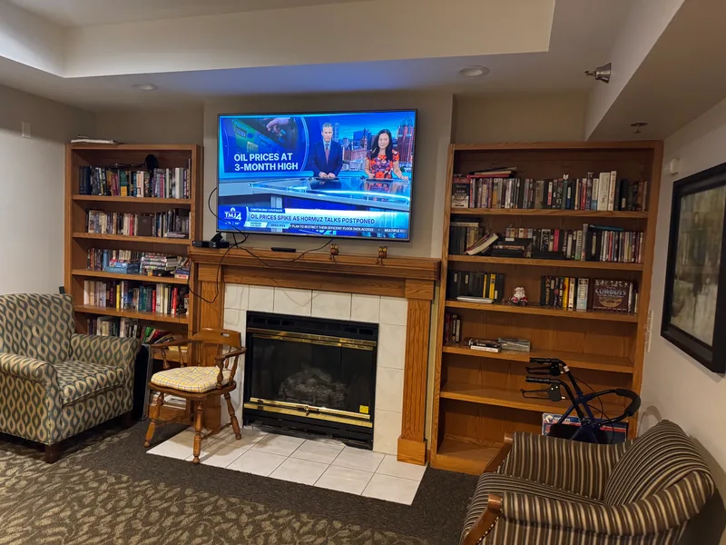 Library and TV lounge with fireplace at Adava Care Glendale