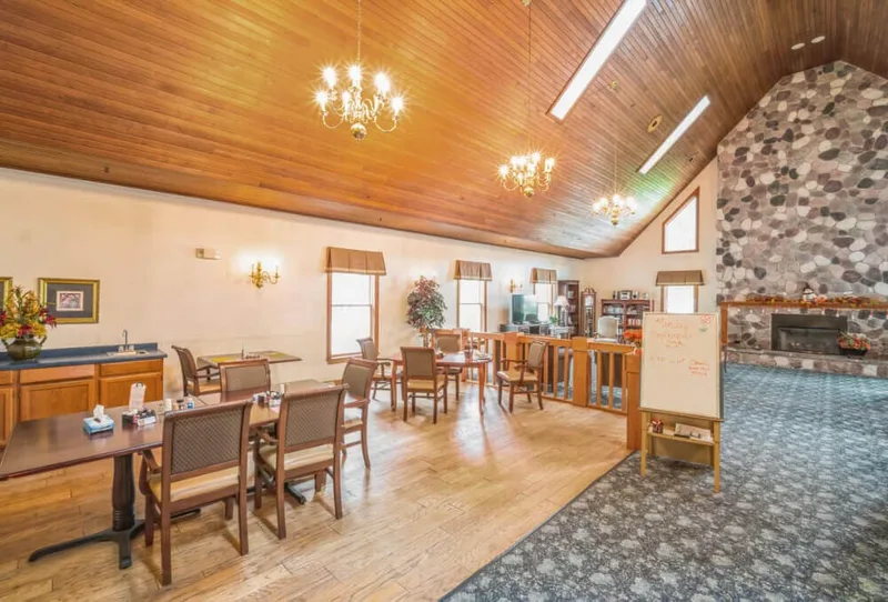 Dining area with chandeliers and wood ceiling at Adava Care Hartland in Hartland, WI