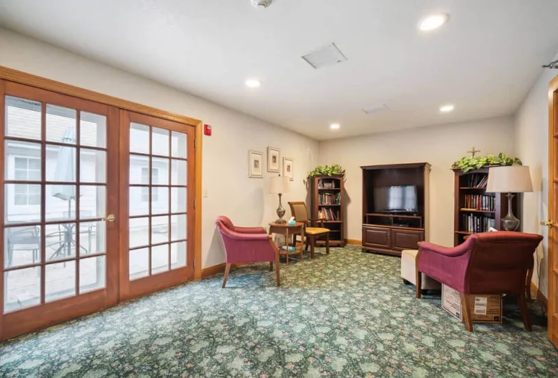 Sitting room with French doors leading to the patio at Adava Care Hartland in Hartland, WI